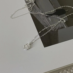 Macro detail of S925 sterling silver bean pendant with unique hammered texture surface