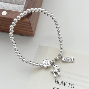 Detailed macro view of S925 sterling silver bead bracelet with lucky horse and mahjong charms