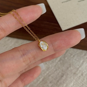 Minimalist S925 sterling silver gold necklace with oval zircon pendant on a model hand