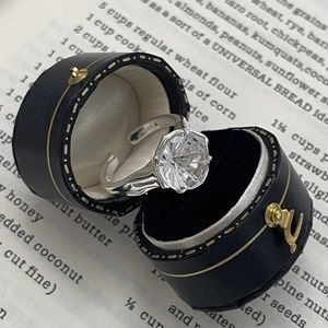 Macro shot of S925 sterling silver ring with 6-prong zircon setting and vintage box