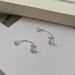 Macro view of S925 sterling silver bow knot C-shape earrings with a polished finish