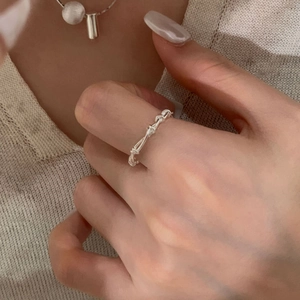 Detail showing a multilayered S925 sterling silver grid ring worn on a finger