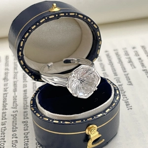 Macro shot of S925 sterling silver ring with fireworks cut white zircon in a jewelry box