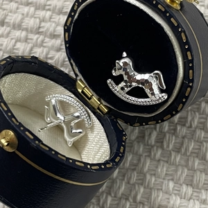 Detailed close-up of S925 silver rocking horse stud earrings with pavé zircon stones
