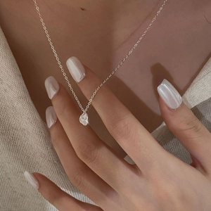 Detailed view of an S925 sterling silver necklace with a minimalist textured pendant