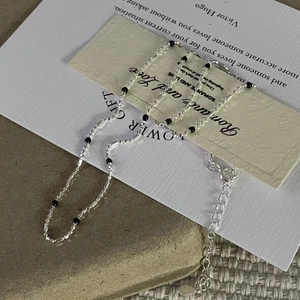 Detail of S925 sterling silver chain with black beads and adjustable lobster clasp closure