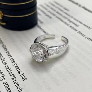 Close-up of S925 sterling silver ring with large round zircon on vintage book pages