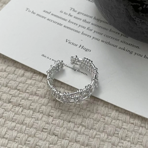 Macro detail of S925 sterling silver multilayer woven lattice open ring with polished finish