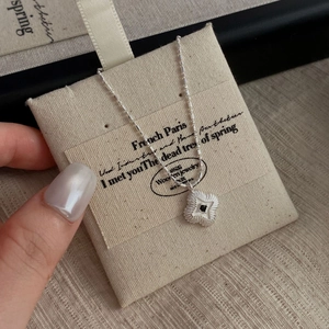 S925 silver four-leaf clover necklace with black zircon on beige jewelry bag