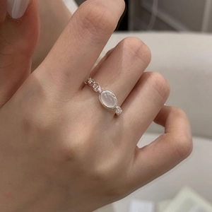 Elegant S925 silver ring with oval white chalcedony and hollow vintage pattern on finger