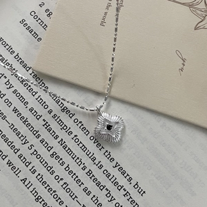 Detailed macro view of S925 silver star pendant with black zircon on fine bead chain