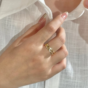 Detailed view of minimalist gold S925 silver rings set with white zircon stones