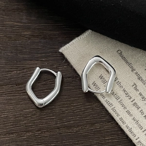 Minimalist S925 sterling silver irregular geometric hoop earrings on dark wood