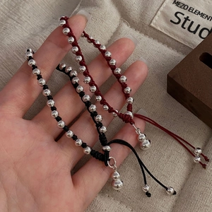 Detail of adjustable S925 silver gourd charm bracelet with red and black woven rope