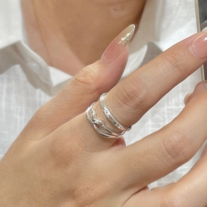 Detail of S925 sterling silver layered ring with zircon inlays on model hand