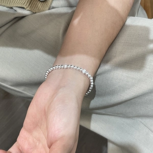 Close-up of S925 sterling silver beaded bracelet with polished and striped textured beads