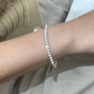 Detailed close-up of a S925 sterling silver beaded bracelet with striped metal beads