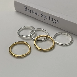 Detail of stacked S925 sterling silver and gold plated rings with small zircon stones