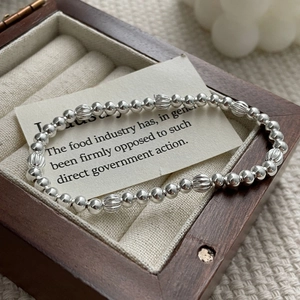 Detailed view of S925 sterling silver beaded bracelet with striped pumpkin charms