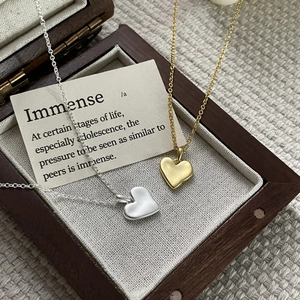 Minimalist S925 sterling silver heart necklaces in gold and silver finish on wooden box