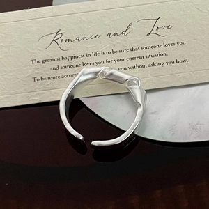 Detail of S925 sterling silver knotted ring with an irregular twisted design