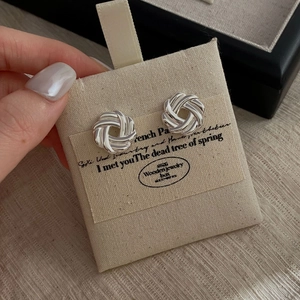 Minimalist 925 sterling silver multi-strand knot stud earrings on a canvas display card