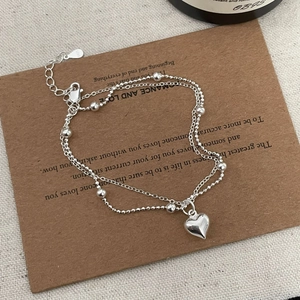 Detailed close-up of a S925 sterling silver double-layer heart bracelet and lobster clasp