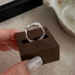Minimalist S925 sterling silver knotted ring with matte finish and organic lava texture