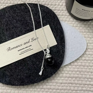 Detail view of S925 sterling silver chain with black crystal pendant on a card