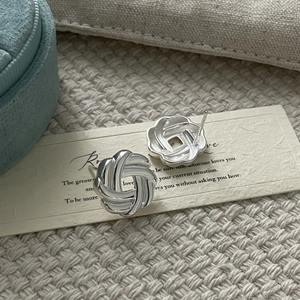 Macro shot of 925 sterling silver multi-strand knot earrings on a display card