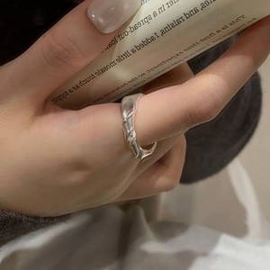 Detail view of a minimalist S925 sterling silver knotted ring with unique twisted texture