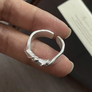 Close-up of S925 sterling silver knot ring with inner band hallmark and matte finish