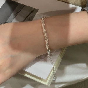 Detail of S925 sterling silver multilayer adjustable chain bracelet with ball drop charm