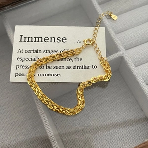 Detailed macro view of S925 sterling silver gold plated braided chain with lobster clasp