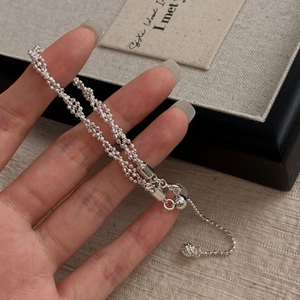 Macro detail of S925 sterling silver multilayer beaded bracelet with adjustable slider ball