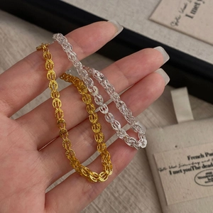 Detailed close-up of gold and silver S925 sterling silver woven link bracelets