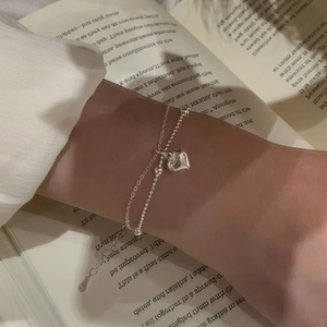 Detail of S925 sterling silver double-layer bracelet with heart pendant and adjustable chain