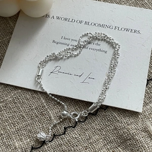 Macro detail of S925 sterling silver multilayer beaded bracelet with adjustable lobster clasp