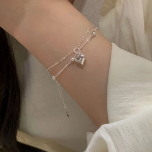 Close-up of double-layer S925 sterling silver bracelet featuring a heart charm and bead chain