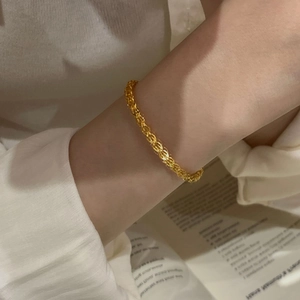 Elegant 925 sterling silver phoenix tail chain bracelet shown on a wrist with a book