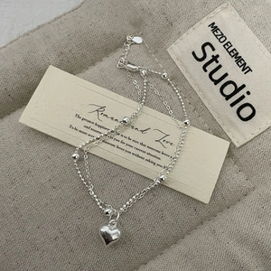 Detailed shot of S925 sterling silver double-layer bracelet with heart charm and beads
