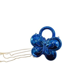 Metallic blue butterfly shaped shoulder bag with round handle and gold chain strap