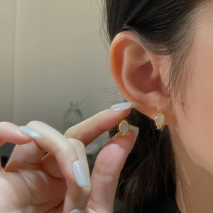 Elegant gold oval shell earrings featuring white inlay and a minimalist French style