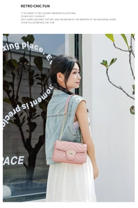Detail of pink quilted PU leather crossbody bag with gold ring buckle and chain strap