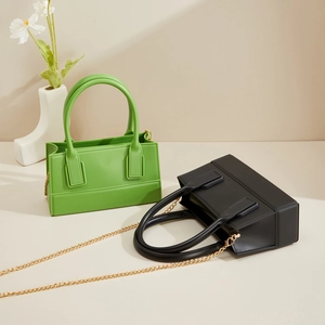 Detail of PVC jelly bag with matte finish featuring golden chain strap and handles