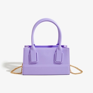 Detail of lavender PVC jelly bag featuring stylish gold chain and dual handles