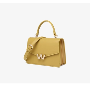 Macro view of mustard yellow PU leather crossbody bag with golden W-shaped metal lock