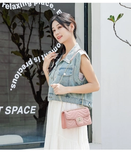 Close-up of pink quilted PU leather bag with V-shaped stitching and metal buckle details