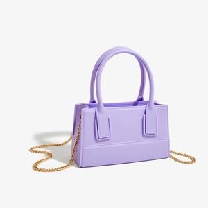 Detailed view of lavender purple square PVC jelly bag with golden chain strap and handles