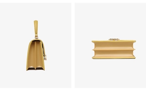Detail view of mustard yellow PU leather handbag showing accordion gusset side and flat base